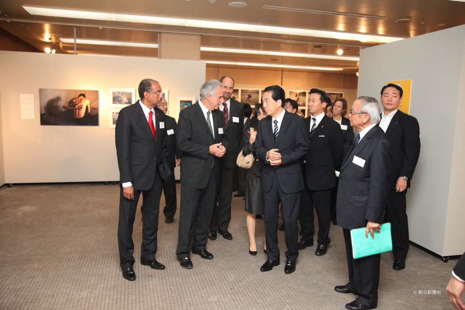 Then Prime Minister Naoto Kan visits the September 2010 opening of a photo exhibit depicting people living with HIV/AIDS